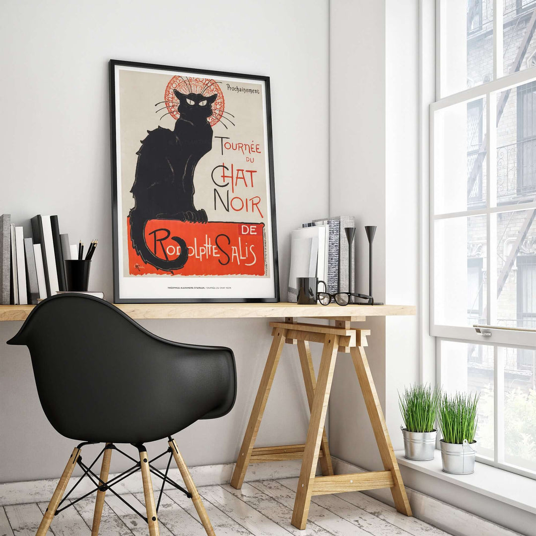 Vintage French black cat poster 'Tournée du Chat Noir' by Steinlen in a stylish home office setting.