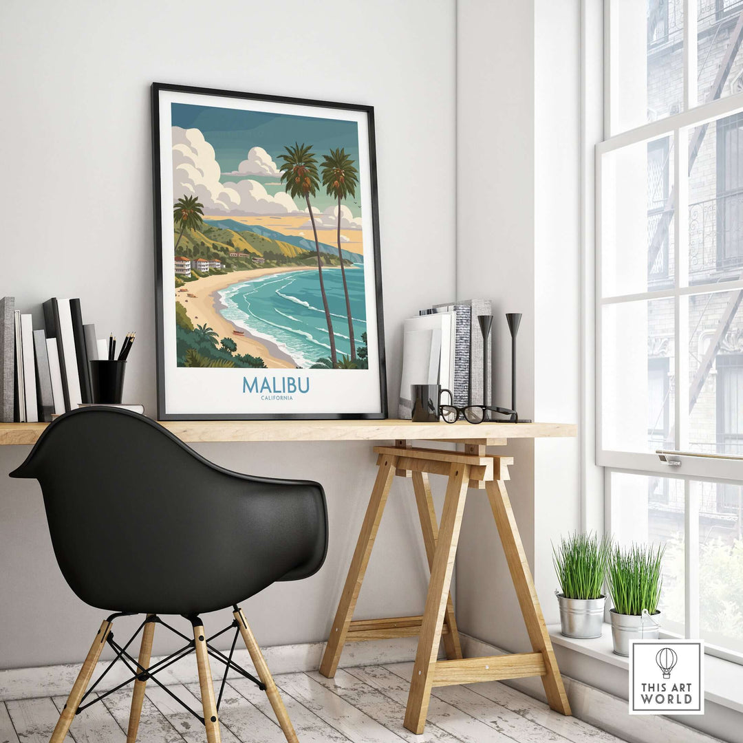 Malibu California beach poster in modern workspace, showcasing coastal scenery and palm trees.
