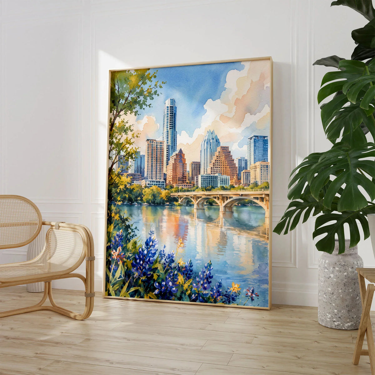 Austin skyline and Lady Bird Lake watercolour art print large framed print beside a chair and plant