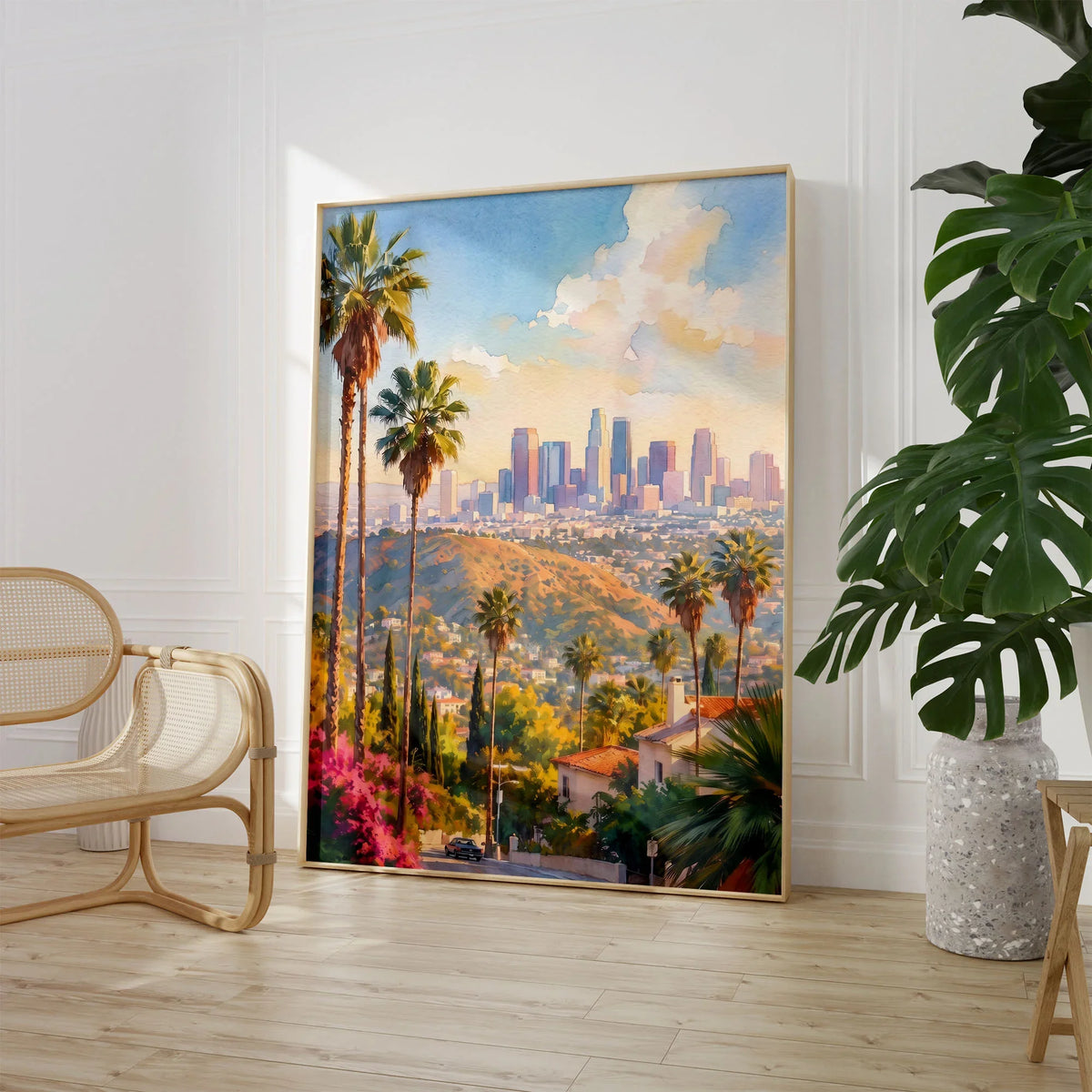 Los Angeles palm trees and downtown skyline watercolour art print large framed print beside a chair and plant