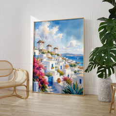 Mykonos windmills and white houses watercolour art print large framed print beside a chair and plant