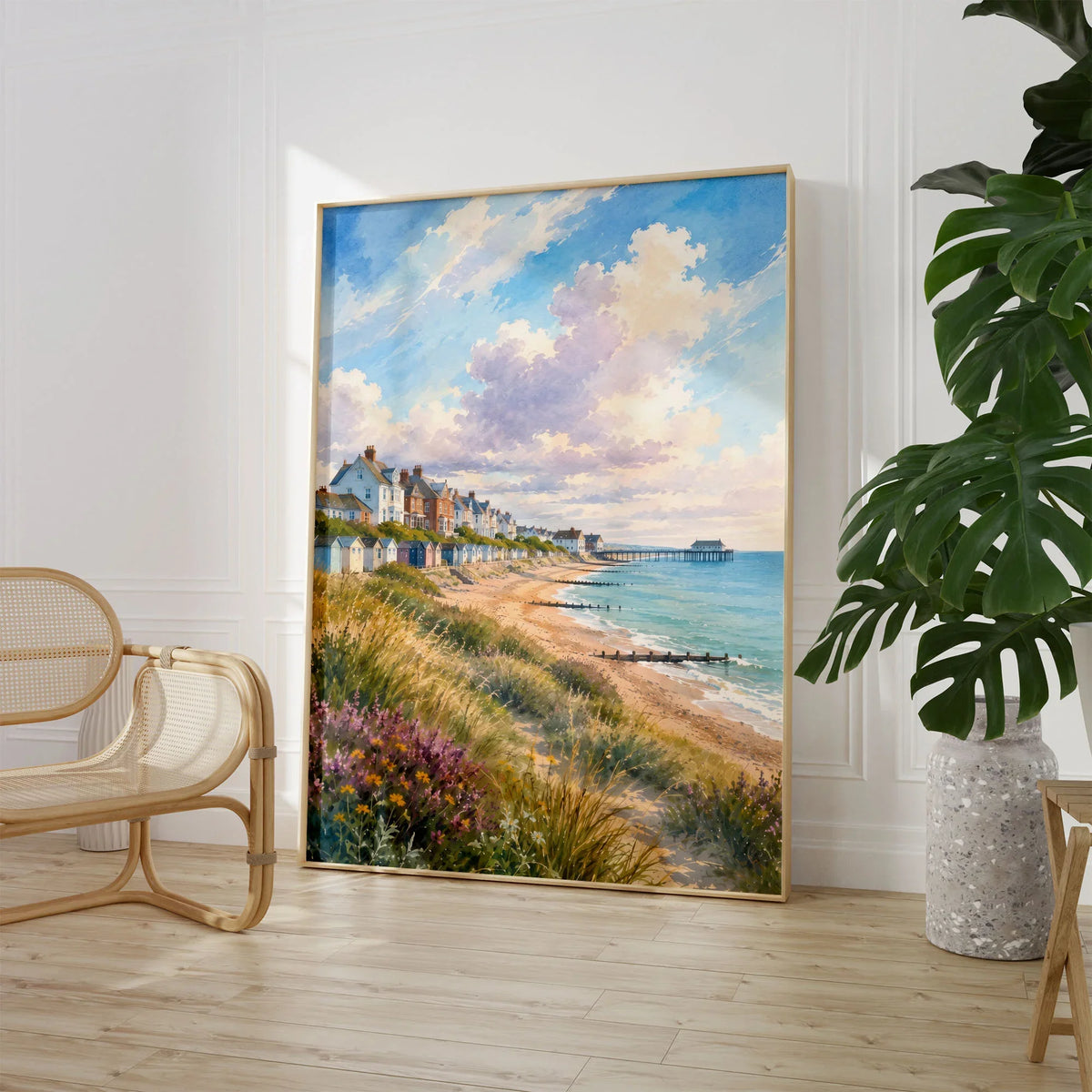 Suffolk Coast Southwold pier and beach huts watercolour art print large framed print beside a chair and plant