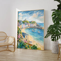 Tenby pastel harbour houses and beach watercolour art print large framed print beside a chair and plant
