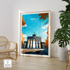 Berlin Poster Blue Sky in a large natural wood frame leaning in a room with a rattan chair and monstera plant
