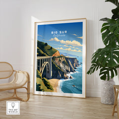 Big Sur Print in a large natural wood frame leaning in a room with a rattan chair and monstera plant