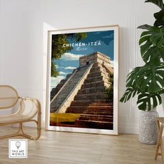 Chichén Itzá Mexico Travel Print El Castillo Pyramid Poster Mayan Ruins Wall Art in a large natural wood frame leaning in a room with a rattan chair and monstera plant