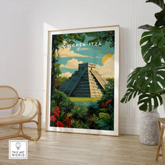 Chichén Itzá Mexico Travel Poster Pyramid Jungle Print Mayan Ruins Wall Art Decor in a large natural wood frame leaning in a room with a rattan chair and monstera plant
