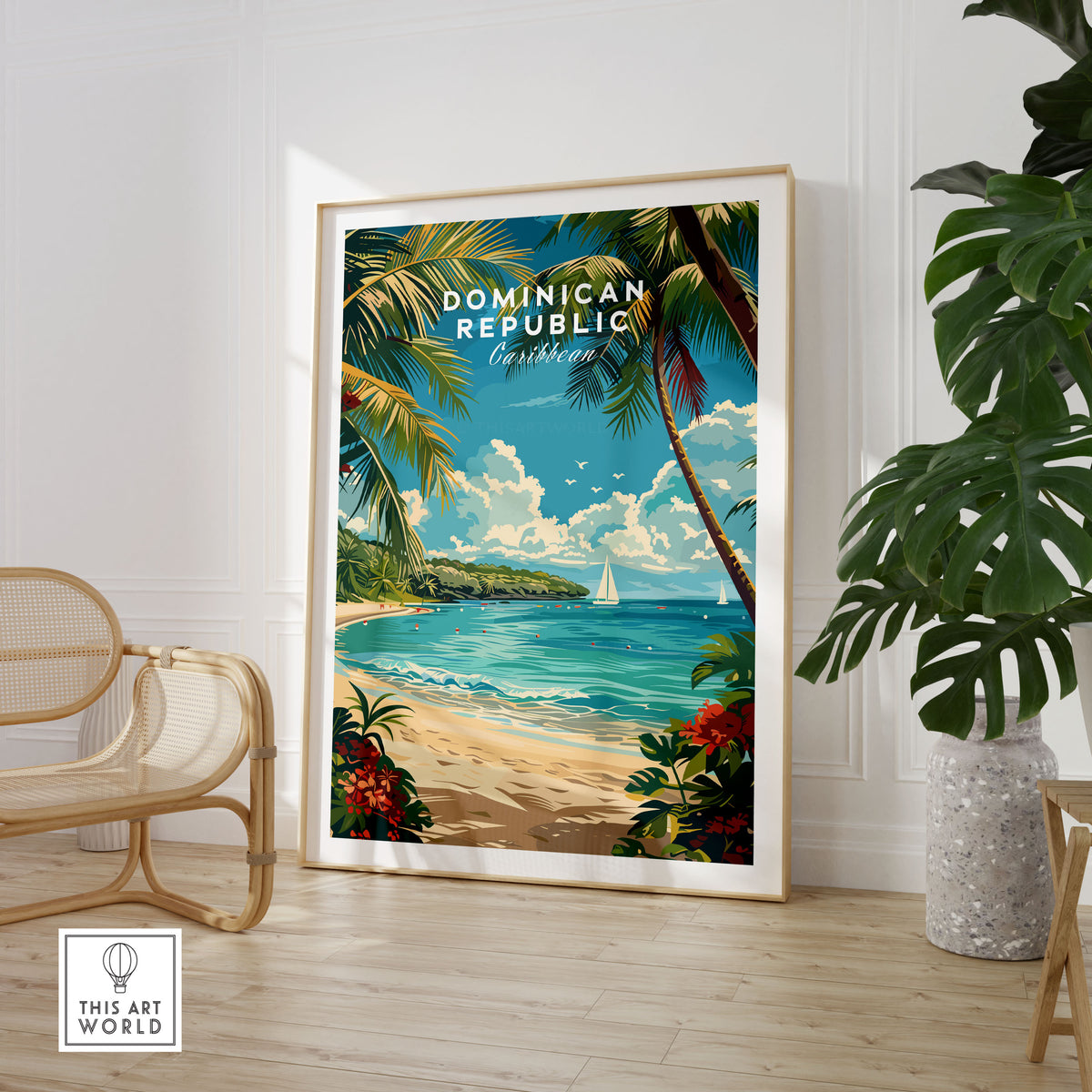 Dominican Republic Travel Print in a large natural wood frame leaning in a room with a rattan chair and monstera plant
