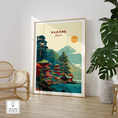 Hakone Japan Lake Ashi Temple Print - Japanese Pagoda Wall Art in a large natural wood frame leaning in a room with a rattan chair and monstera plant