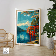 HakonePrint Japan Peace Shrine Torii Artwork - Mount Fuji Lake Ashi Poster in a large natural wood frame leaning in a room with a rattan chair and monstera plant