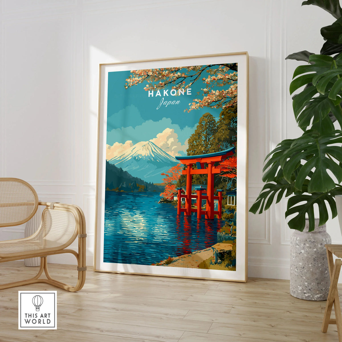 HakonePrint Japan Peace Shrine Torii Artwork - Mount Fuji Lake Ashi Poster in a large natural wood frame leaning in a room with a rattan chair and monstera plant