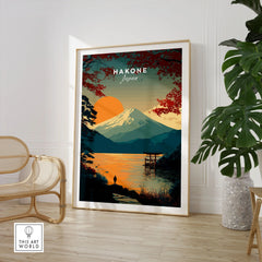Hakone Japan Torii Gate Sunset Poster - Mount Fuji Lake Scene Print in a large natural wood frame leaning in a room with a rattan chair and monstera plant