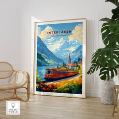 Interlaken Travel Print in a large natural wood frame leaning in a room with a rattan chair and monstera plant
