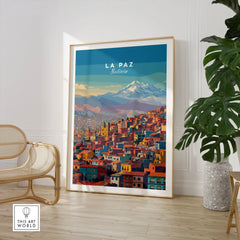 La Paz Bolivia Andes Mountain City Print - Travel Poster in a large natural wood frame leaning in a room with a rattan chair and monstera plant
