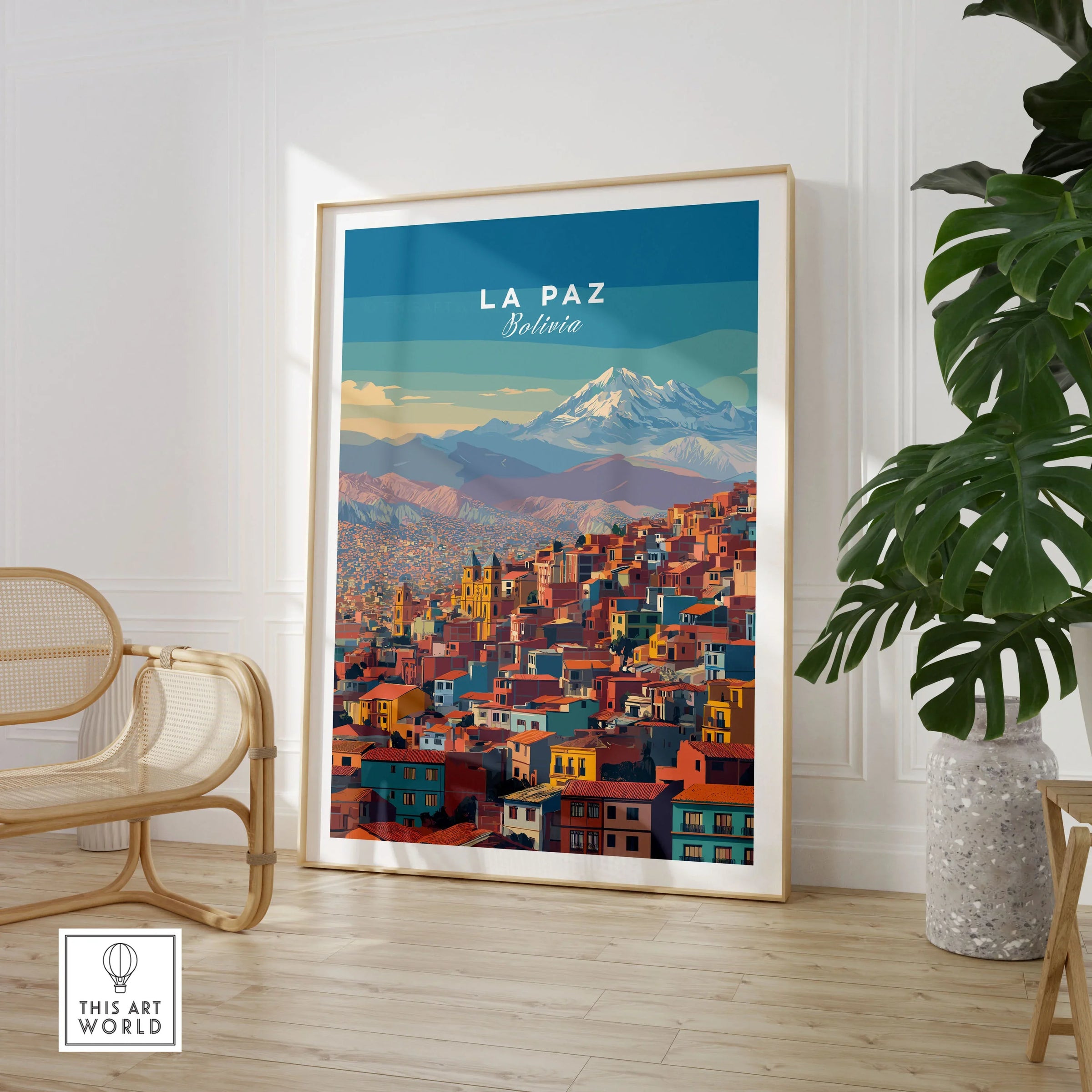 La Paz Bolivia Andes Mountain City Print - Travel Poster in a large natural wood frame leaning in a room with a rattan chair and monstera plant