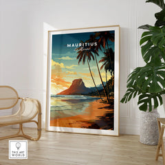 Mauritius Le Morne Poster in a large natural wood frame leaning in a room with a rattan chair and monstera plant