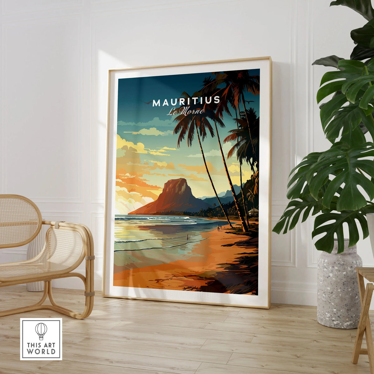 Mauritius Le Morne Poster in a large natural wood frame leaning in a room with a rattan chair and monstera plant