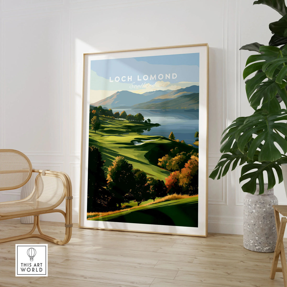 Loch Lomond Scotland Autumn Lochside Travel Poster — autumn slopes rolling down to Loch Lomond with Highland hills beyond, shown as large framed print room setting chair plant