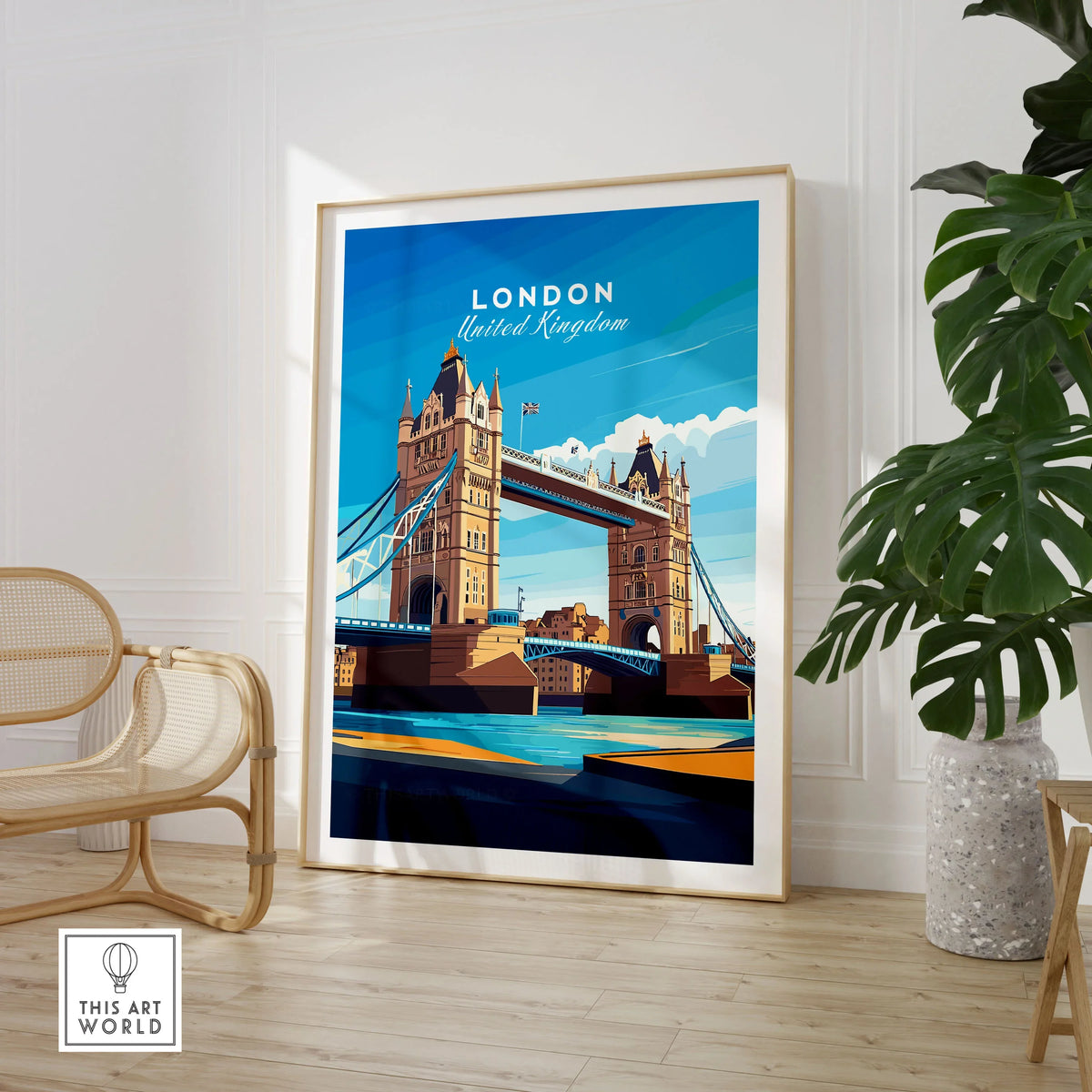London Print England in a large natural wood frame leaning in a room with a rattan chair and monstera plant
