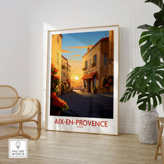 Aix-en-Provence Wall Art in a large natural wood frame leaning in a room with a rattan chair and monstera plant