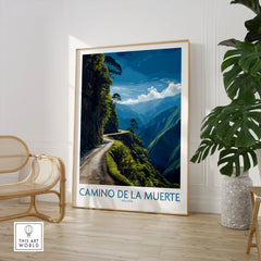 Camino de la Muerte Bolivia Cliff Road Wall Art — the Yungas cliff road curving along a jungle mountainside above the Bolivian Andes, shown as large framed print room setting chair plant