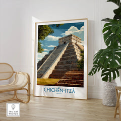 Mexico Chichén Itzá El Castillo Poster Mayan Temple Travel Print Ancient Ruins Wall Art in a large natural wood frame leaning in a room with a rattan chair and monstera plant