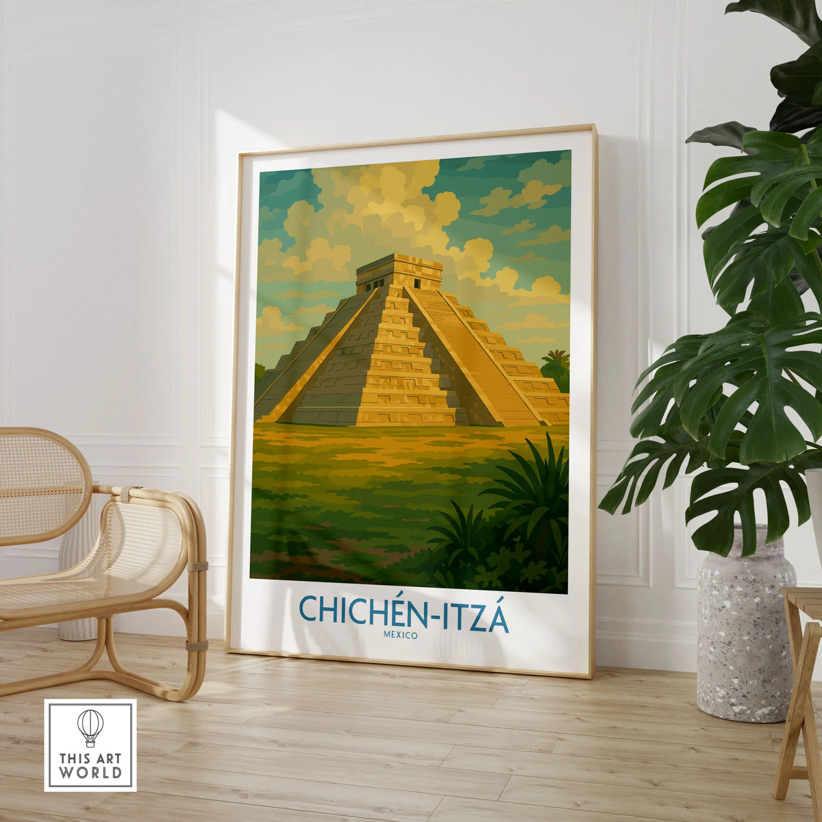 Mexico Mayan Pyramid Chichén Itzá Travel Poster El Castillo Landscape Print Wall Art in a large natural wood frame leaning in a room with a rattan chair and monstera plant