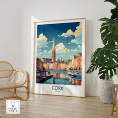 Cork Ireland Poster in a large natural wood frame leaning in a room with a rattan chair and monstera plant