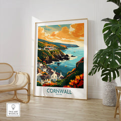 Cornwall Art Print - Modern in a large natural wood frame leaning in a room with a rattan chair and monstera plant