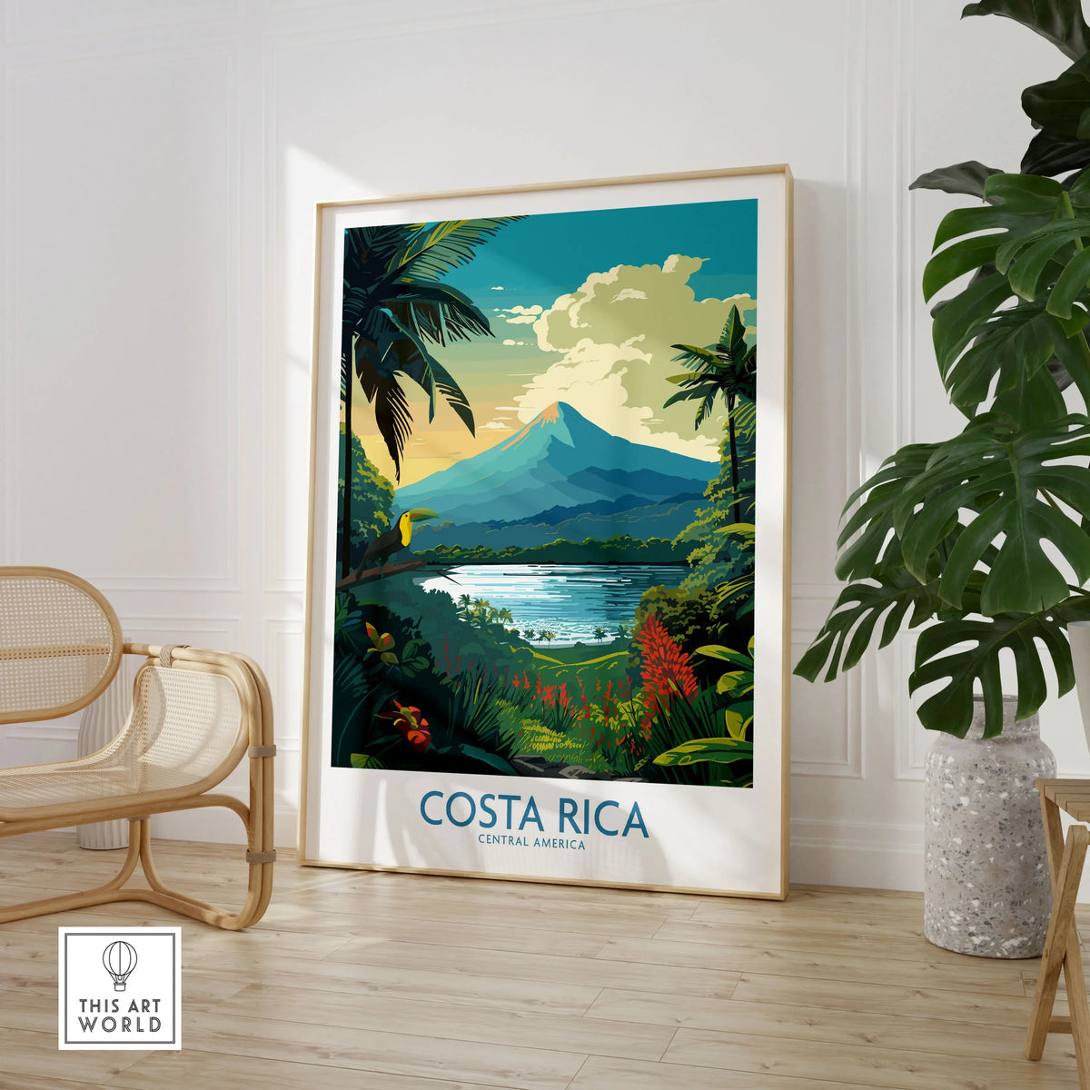 Costa Rica Wall Art | Modern Style in a large natural wood frame leaning in a room with a rattan chair and monstera plant