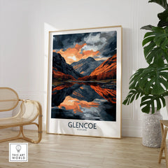 Glencoe Wall Art Poster in a large natural wood frame leaning in a room with a rattan chair and monstera plant