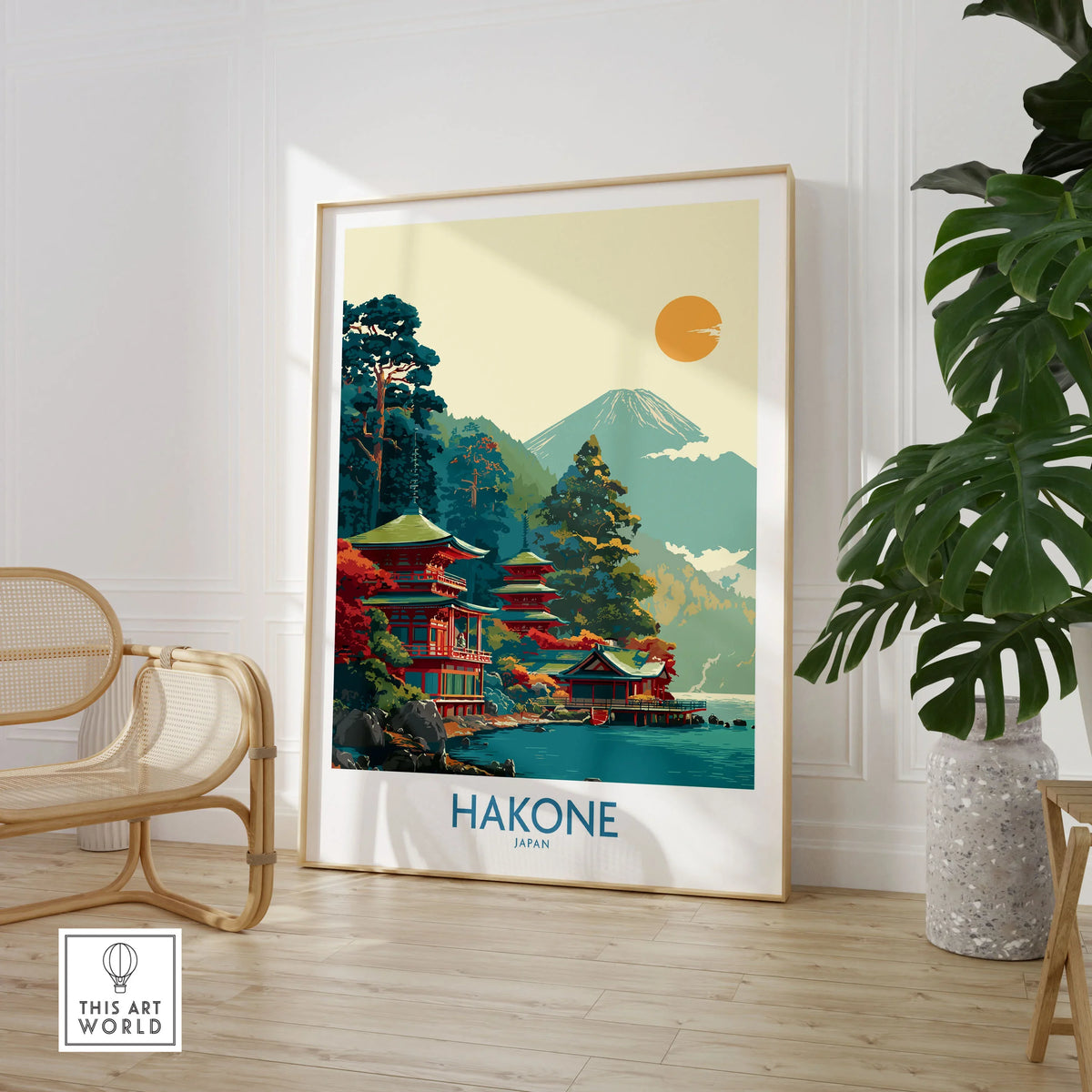 Hakone Japan Lake Ashi Temple Print - Japanese Pagoda Wall Art - Modern in a large natural wood frame leaning in a room with a rattan chair and monstera plant