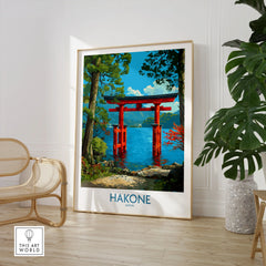 Hakone Japan Iconic Torii Print - Japanese Scenic Landscape Decor in a large natural wood frame leaning in a room with a rattan chair and monstera plant