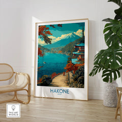 Hakone Japan Lakeside Temple Wall Art - Japanese Nature Travel Decor in a large natural wood frame leaning in a room with a rattan chair and monstera plant