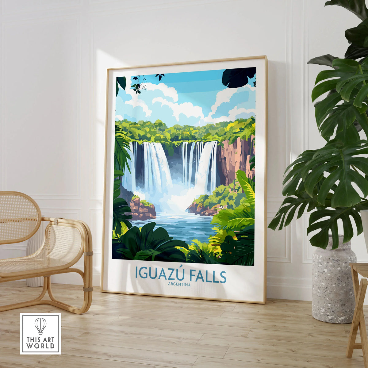 Iguazu Falls Travel Poster in a large natural wood frame leaning in a room with a rattan chair and monstera plant