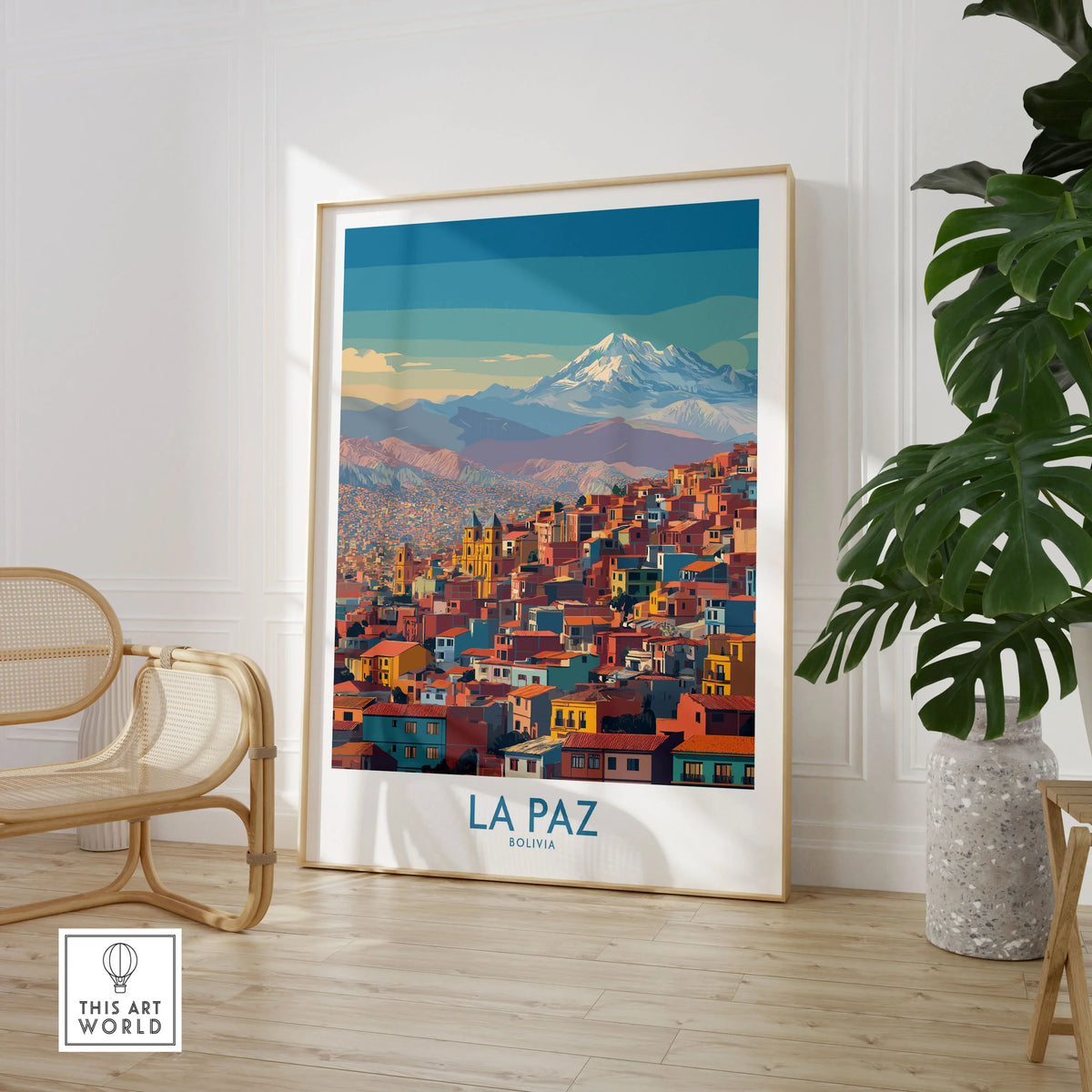 La Paz Bolivia Urban Landscape Wall Art - South American City Print in a large natural wood frame leaning in a room with a rattan chair and monstera plant
