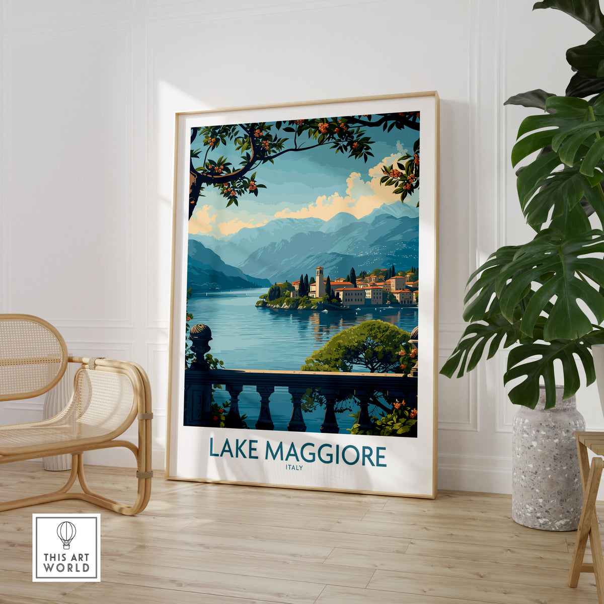 Lake Maggiore Poster Italy in a large natural wood frame leaning in a room with a rattan chair and monstera plant