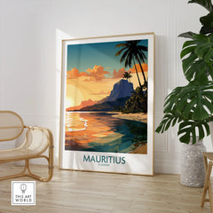 Le Morne Mauritius Wall Art in a large natural wood frame leaning in a room with a rattan chair and monstera plant