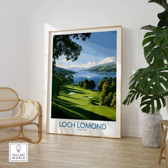 Loch Lomond Scotland Lochside Meadow Wall Art — a sunlit grassy shoreline running down to Loch Lomond under old oaks, shown as large framed print room setting chair plant