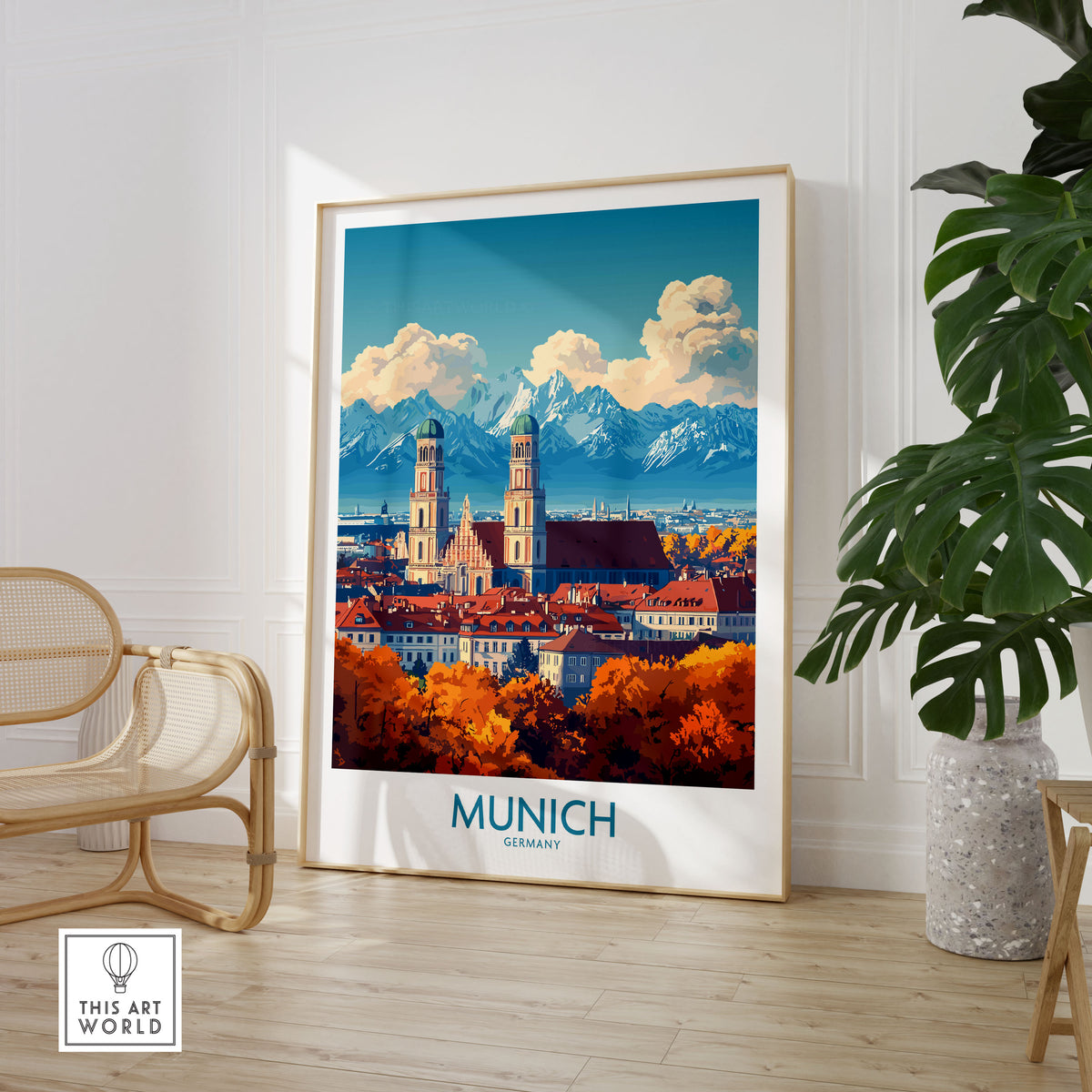 Munich Travel Poster in a large natural wood frame leaning in a room with a rattan chair and monstera plant