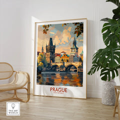 Prague Travel Poster in a large natural wood frame leaning in a room with a rattan chair and monstera plant