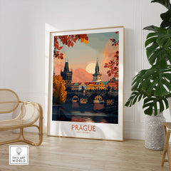 Prague Travel Print in a large natural wood frame leaning in a room with a rattan chair and monstera plant