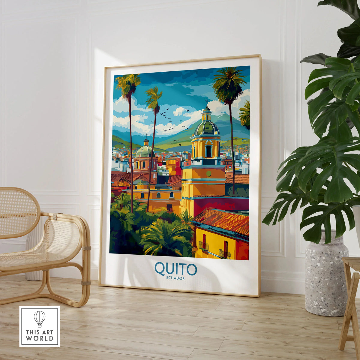 Ecuador Quito Cityscape Travel Print Poster Colonial Churches Andes Mountain Wall Art in a large natural wood frame leaning in a room with a rattan chair and monstera plant