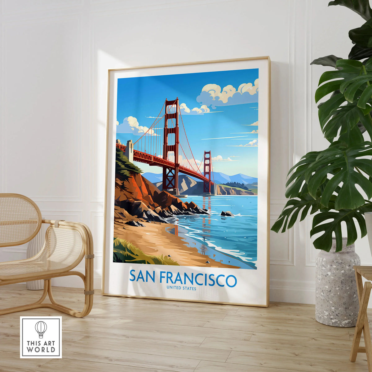 San Francisco Poster in a large natural wood frame leaning in a room with a rattan chair and monstera plant