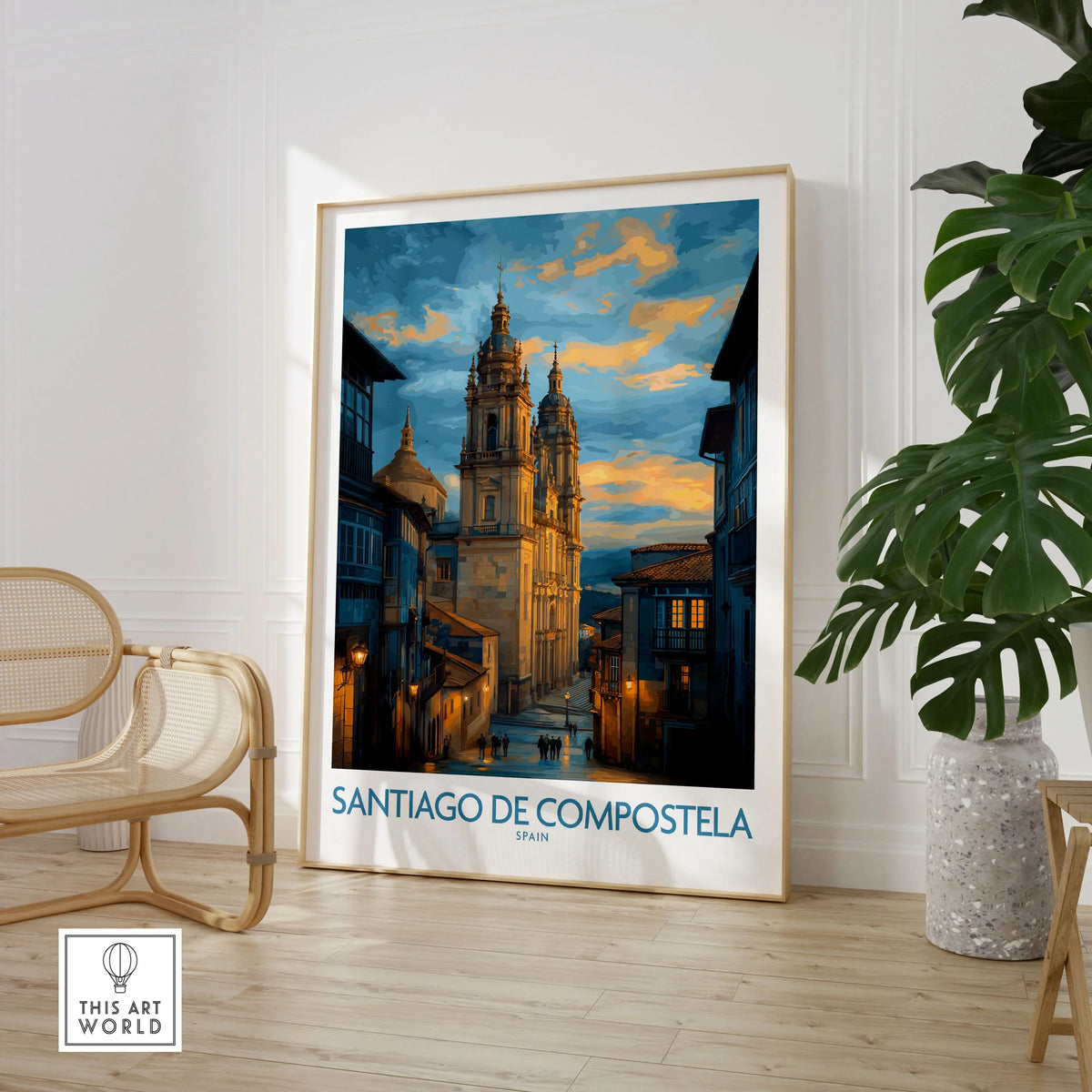 Santiago de Compostela Cathedral Art Print | Cityscape Poster in a large natural wood frame leaning in a room with a rattan chair and monstera plant