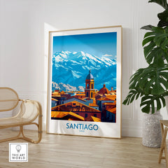 Santiago Wall Art Poster - Chile in a large natural wood frame leaning in a room with a rattan chair and monstera plant