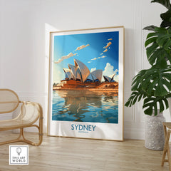 Sydney Print in a large natural wood frame leaning in a room with a rattan chair and monstera plant