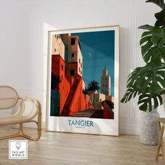 Tangier Morocco Crescent Moon Wall Art — coral kasbah steps climbing towards a minaret under a crescent moon, shown as large framed print room setting chair plant