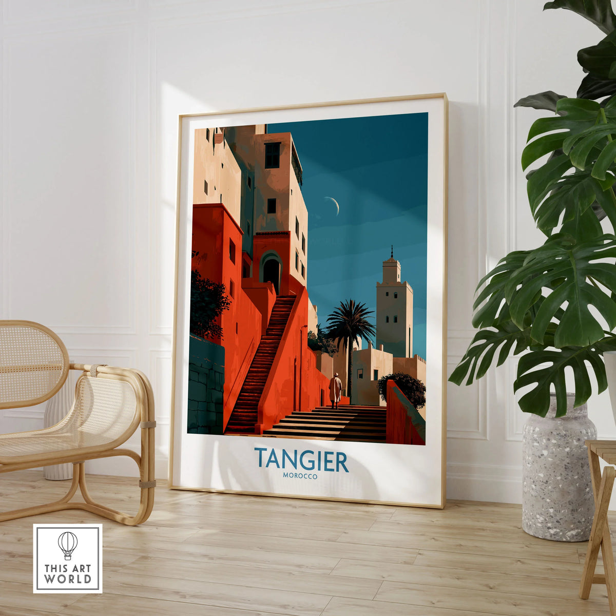 Tangier Morocco Crescent Moon Wall Art — coral kasbah steps climbing towards a minaret under a crescent moon, shown as large framed print room setting chair plant