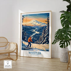 Whistler Ski Print - British Columbia in a large natural wood frame leaning in a room with a rattan chair and monstera plant
